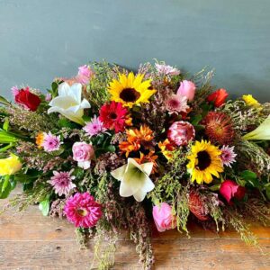 mixed flower coffin arrangement